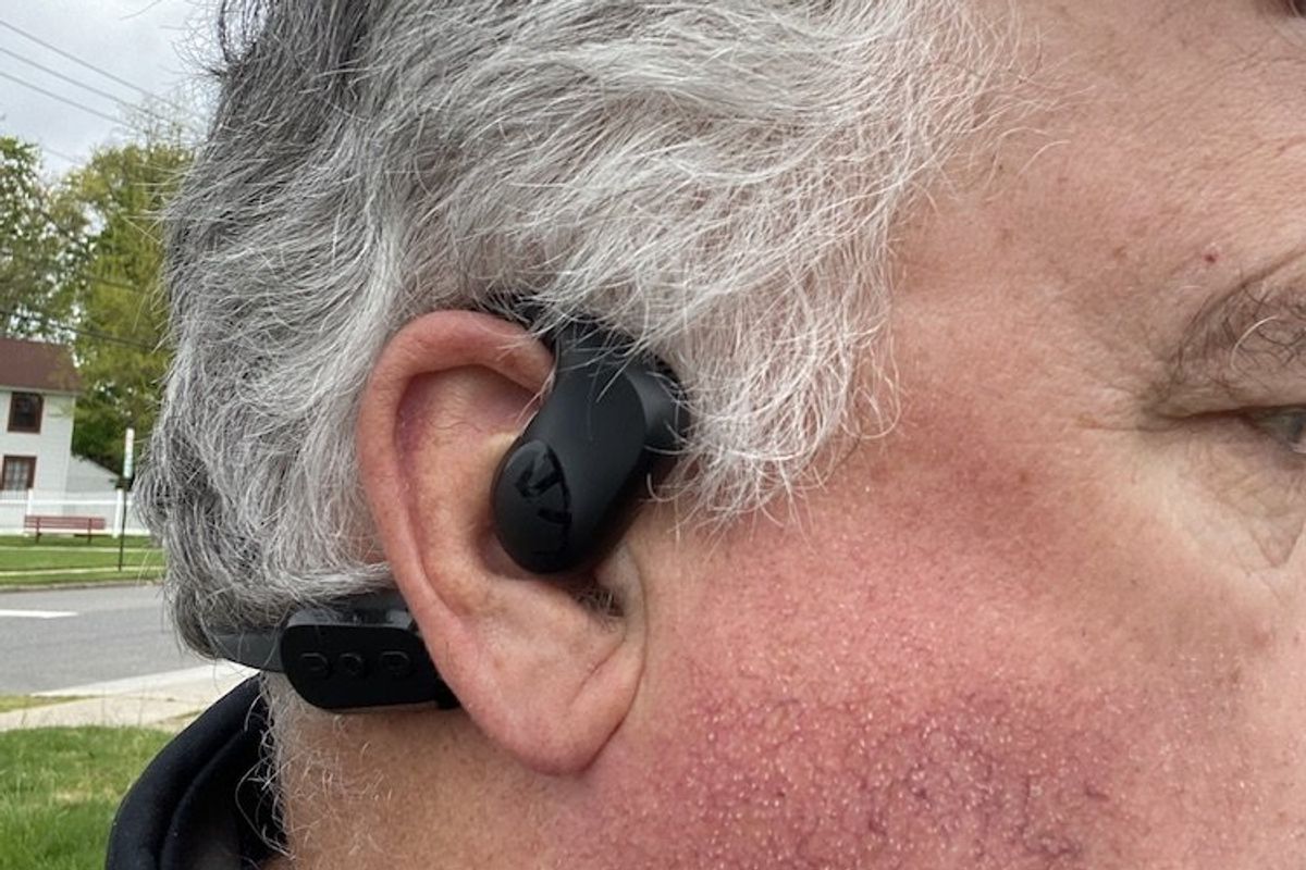 a photo wearing Soundpeats RunFree Lite headphones outside