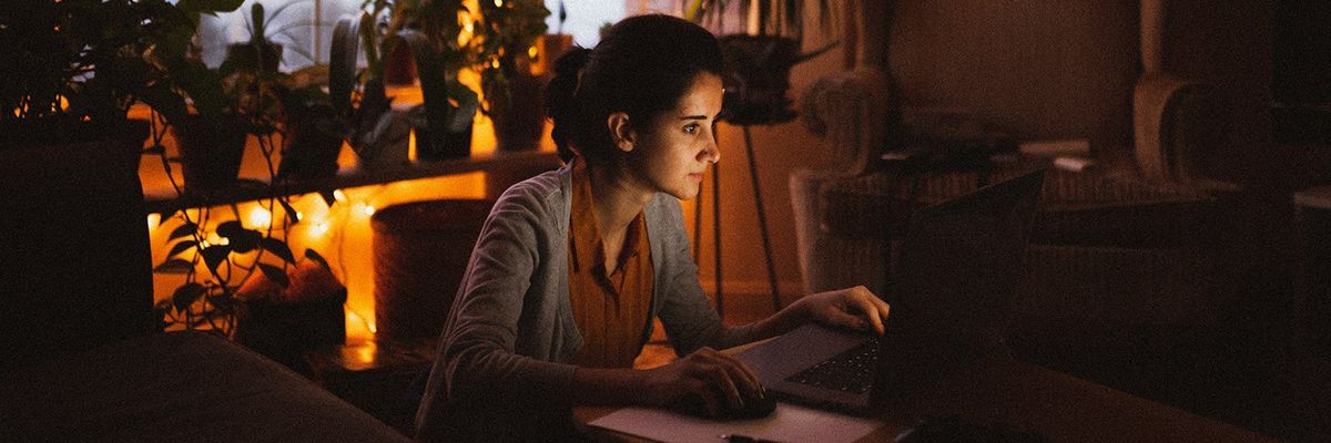 woman at her laptop at night