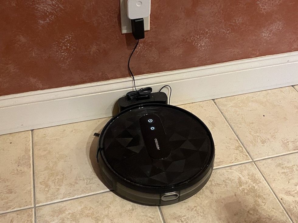 a photo of the Airrobo P20 Robot Vacuum Cleaner plugged into its charging station