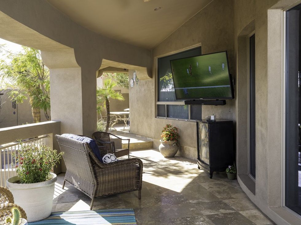 a photo of an outdoor tv by Furrion on a porch