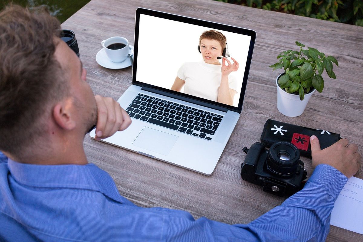 a man on a video conferencing call on his laptop