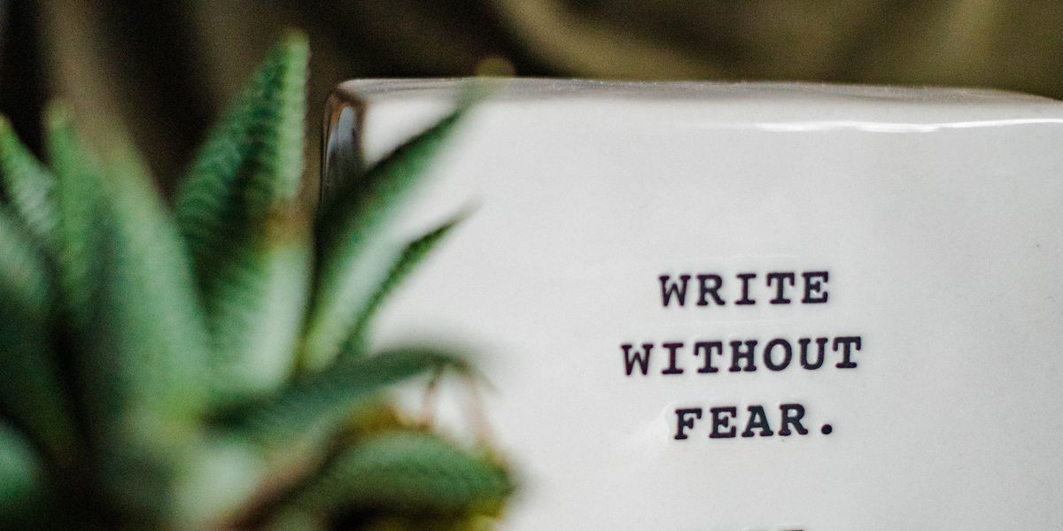 the words write without fear on a white ceramic block