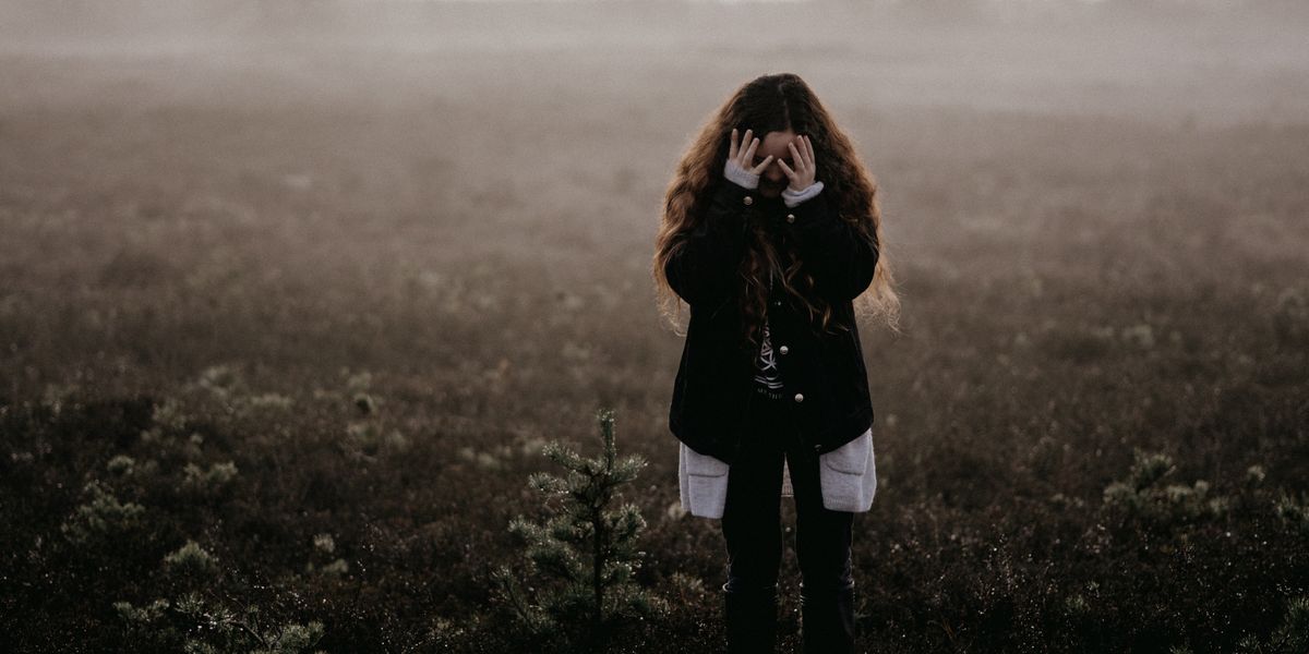 Woman covering her face in embarrassment