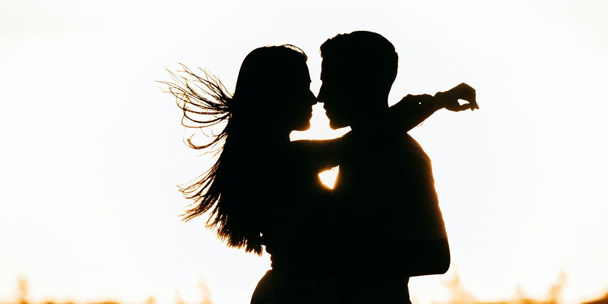 Silhouette of a couple kissing