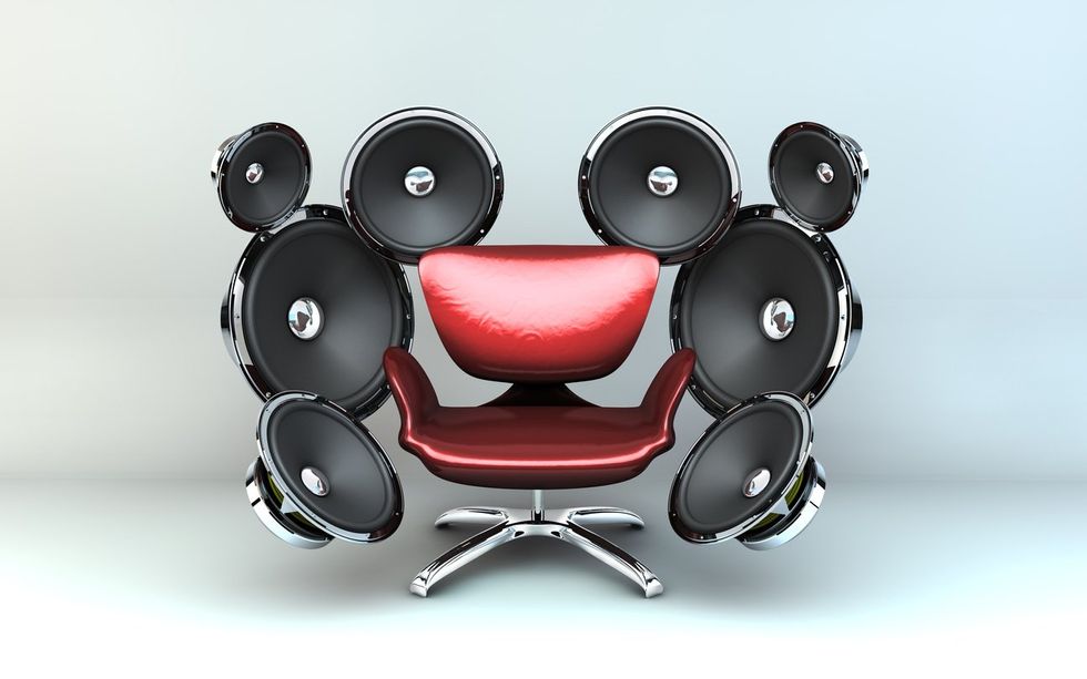 a photo of a chair with speakers all around