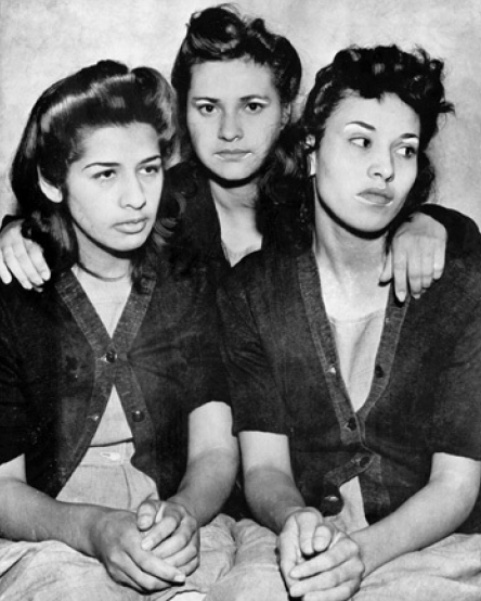 Three women, Dora Barrios, Frances Silva, and Lorena Encinas, standing together in a posed group portrait.