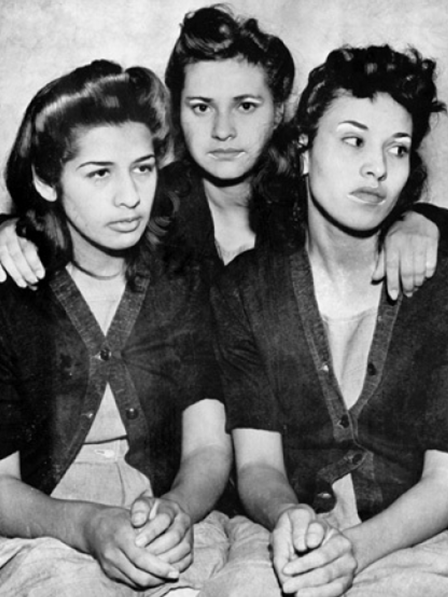 Three women, Dora Barrios, Frances Silva, and Lorena Encinas, standing together in a posed group portrait.
