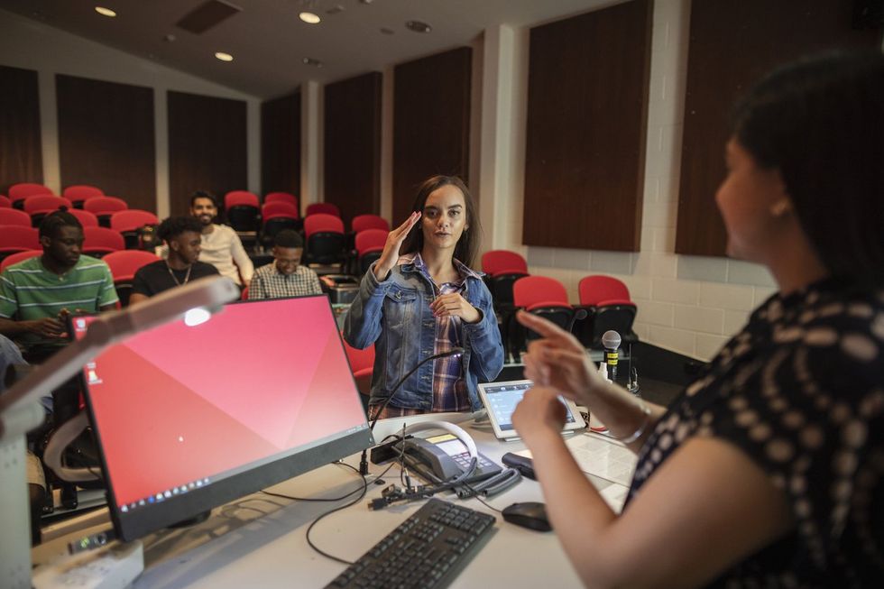 student using sign language in a classroom