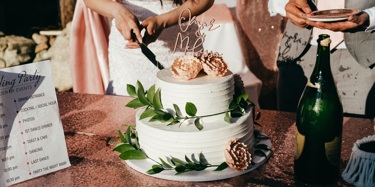 Bride slicing wedding cake