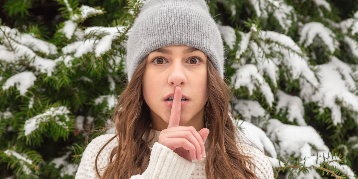 Woman making "shhhh" symbol with finger to lips