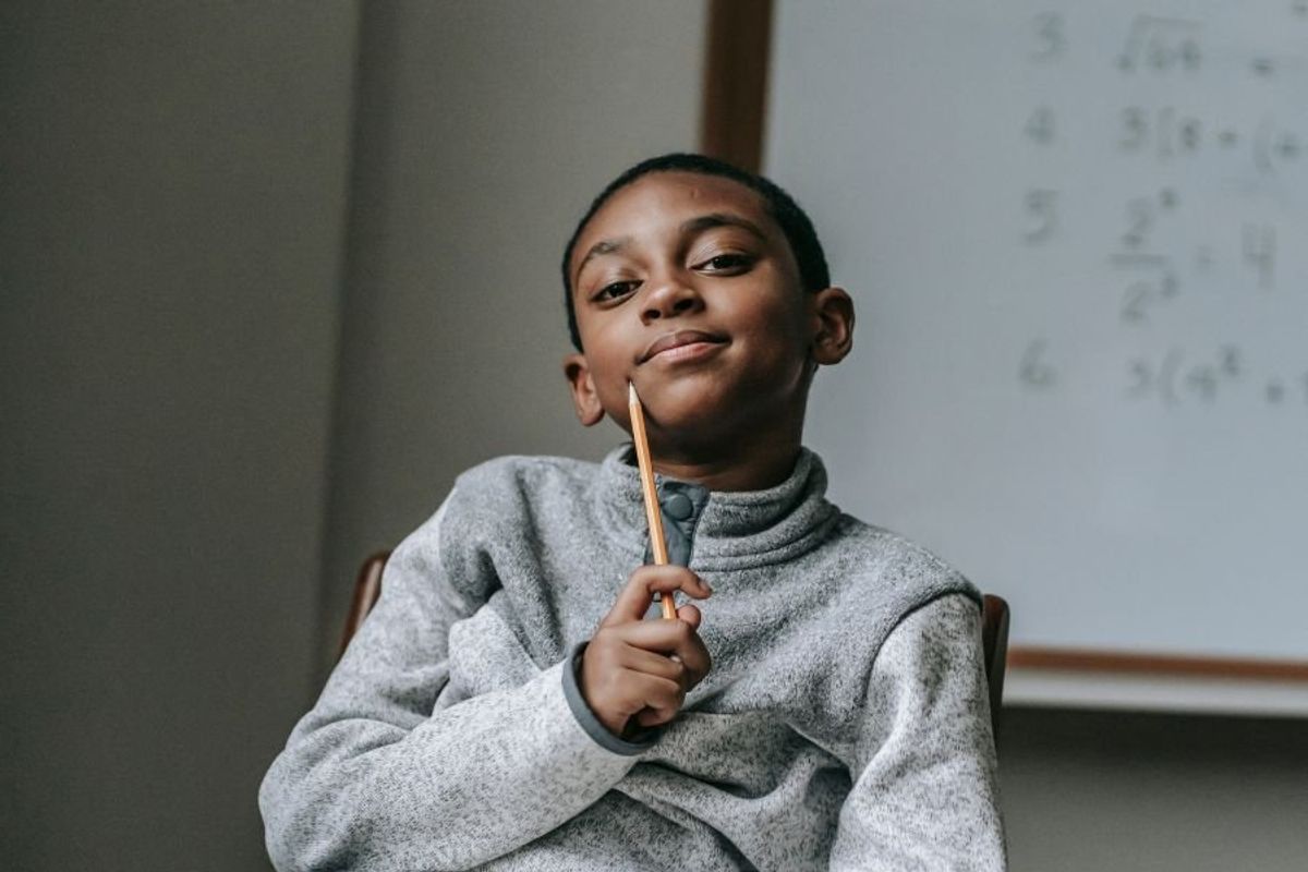 boy smiling in a classroom