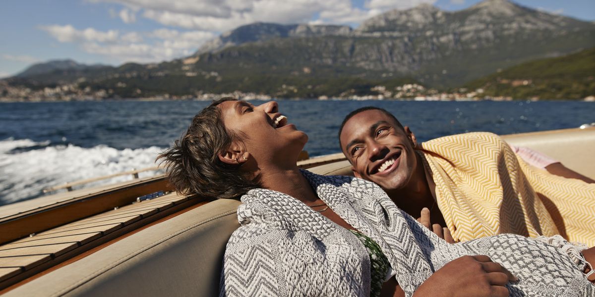 couple-laughing-on-a-boat-on-a-lake