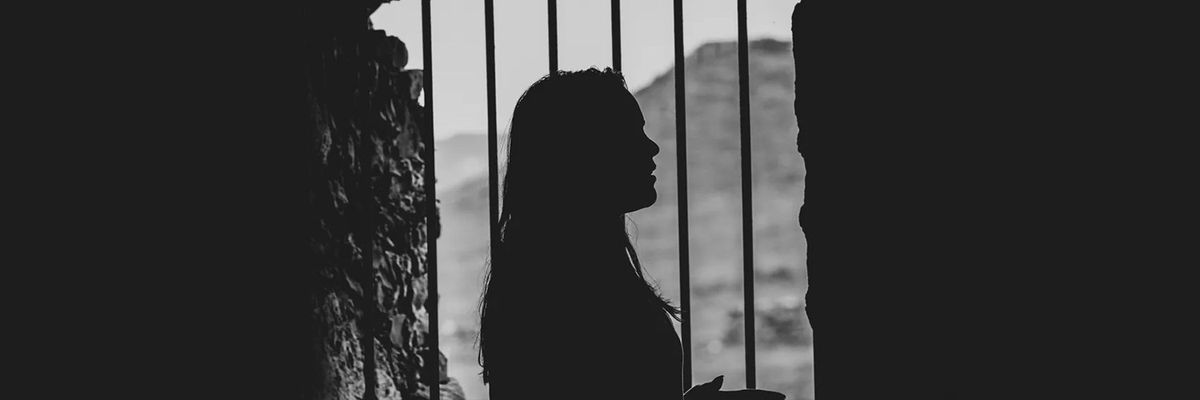 profile shadow of woman by the metal bar window