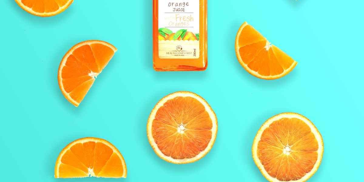 Advertisement for orange juice with blue background and orange slices