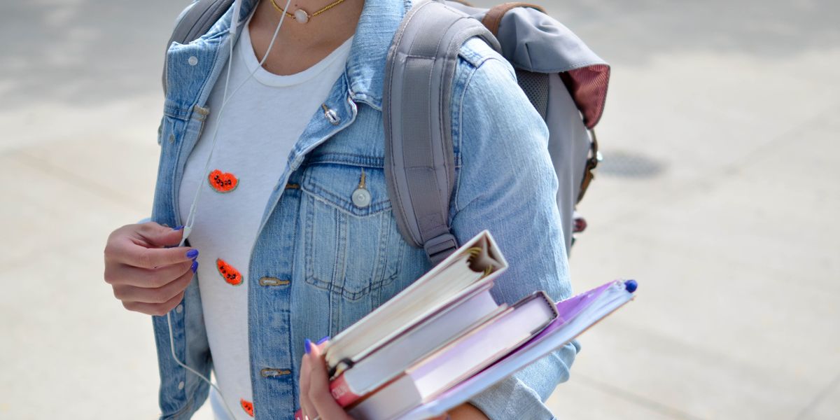 High school student carrying text books.