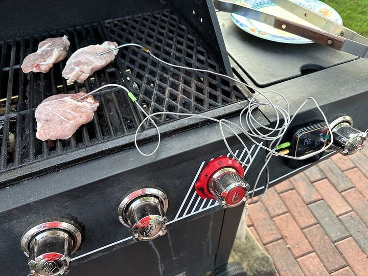 a photo of INKBIRD being used to cook pork chops on the grill