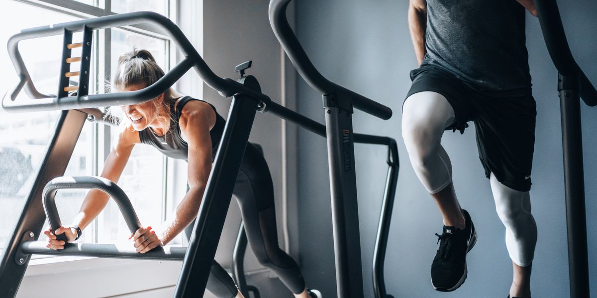 woman in black tank top and black shorts sitting on black exercise equipment