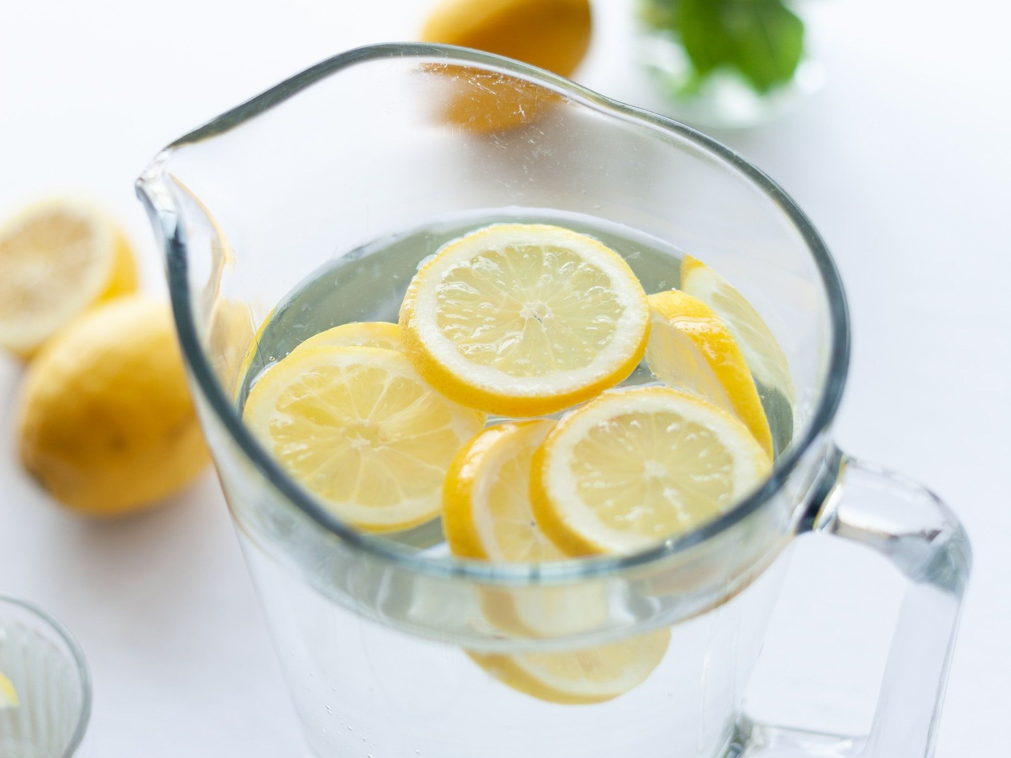 slices of lemons in clear pitcher filled with water