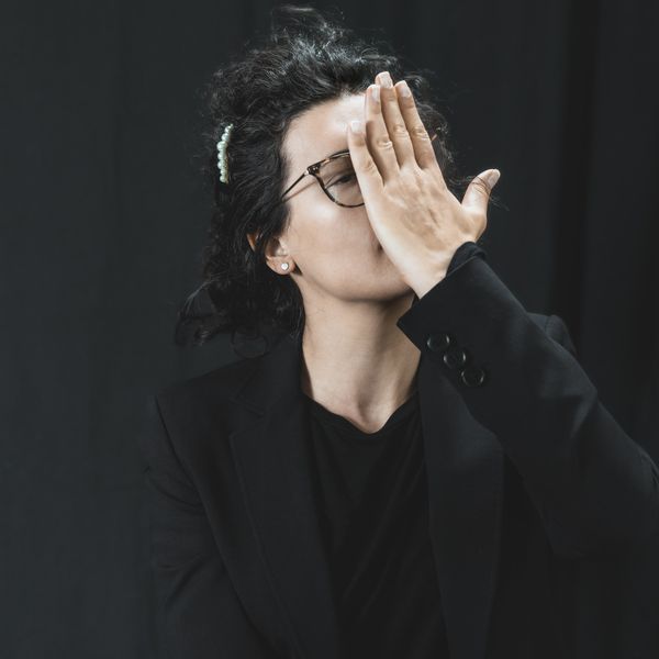 a woman with her hands on her face