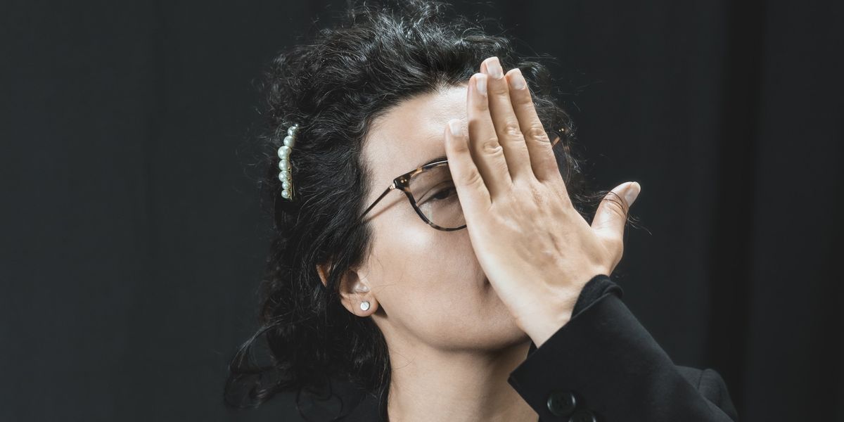 a woman with her hands on her face