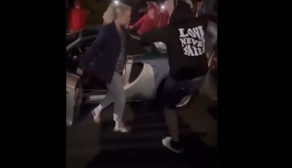 Video: Thug repeatedly kicks woman's car amid violent street takeover — but message on his hoodie may be saddest part