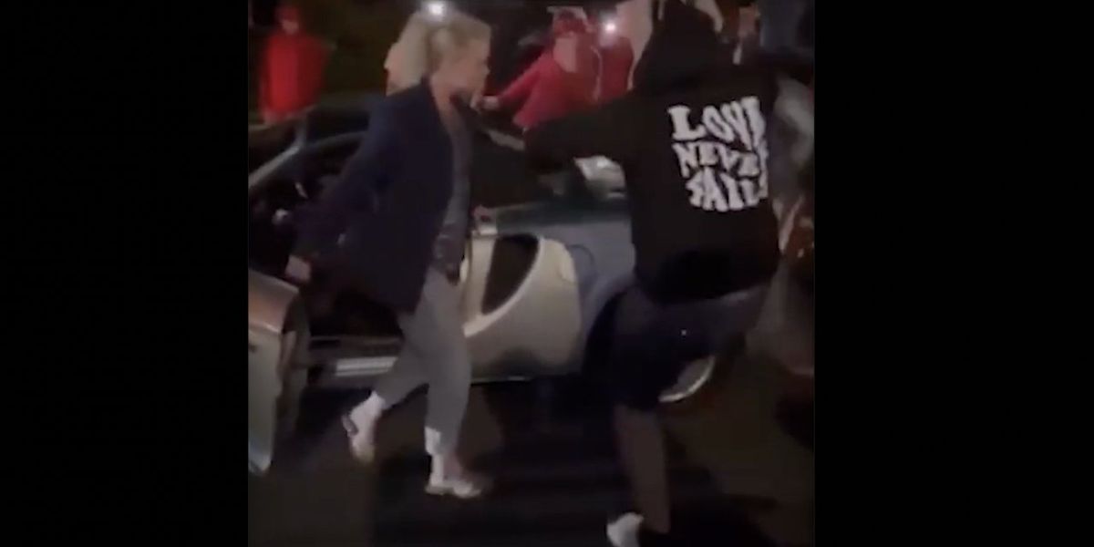 NextImg:Video: Thug repeatedly kicks woman's car amid violent street takeover — but message on his hoodie may be saddest part