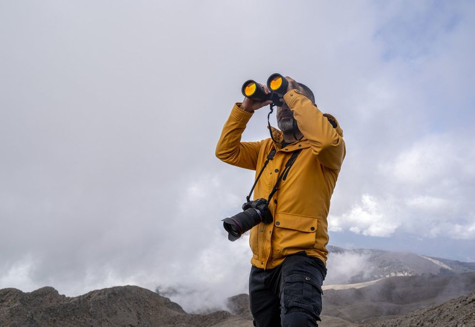 a man using binoculars outdoors