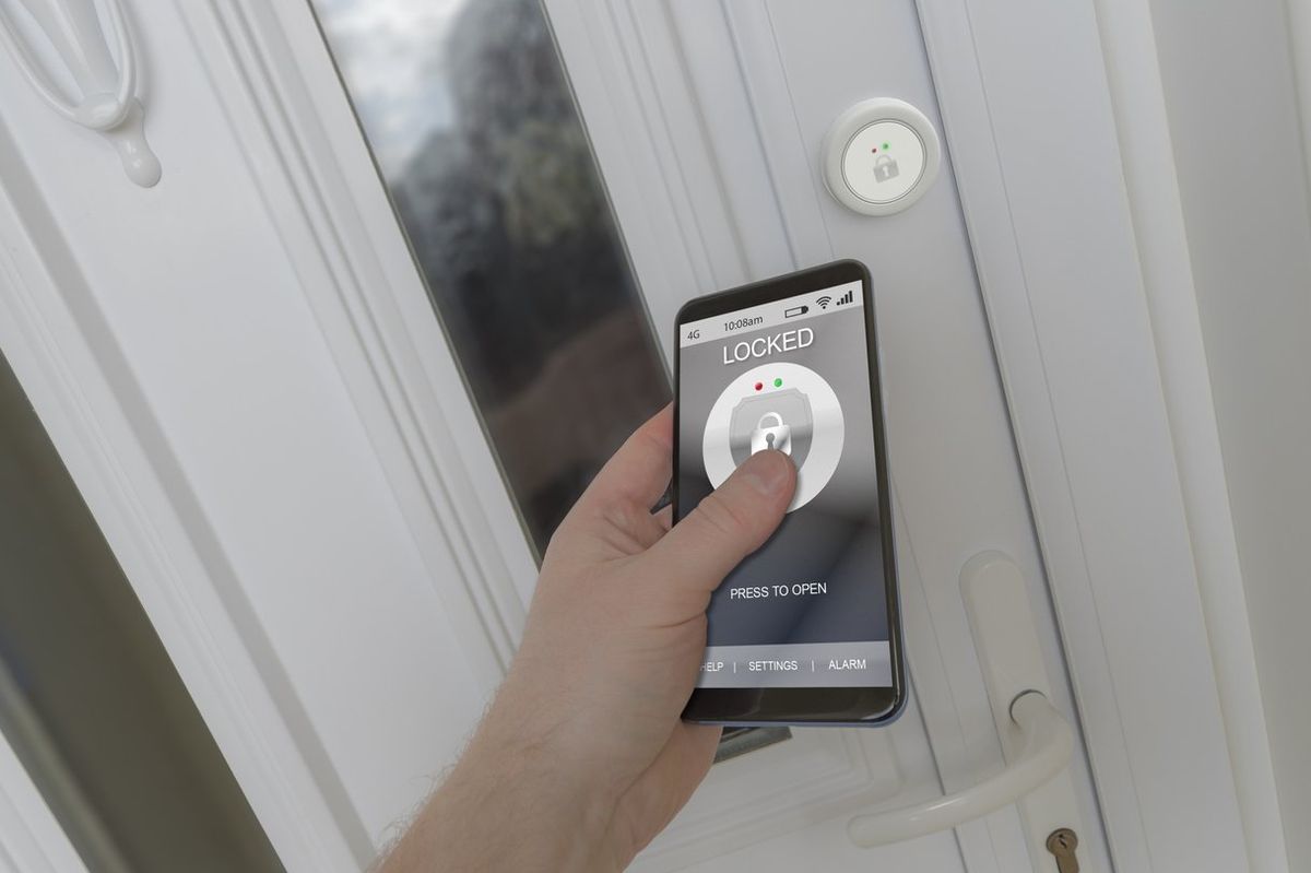 a person using a smartphone to unlock a smart lock