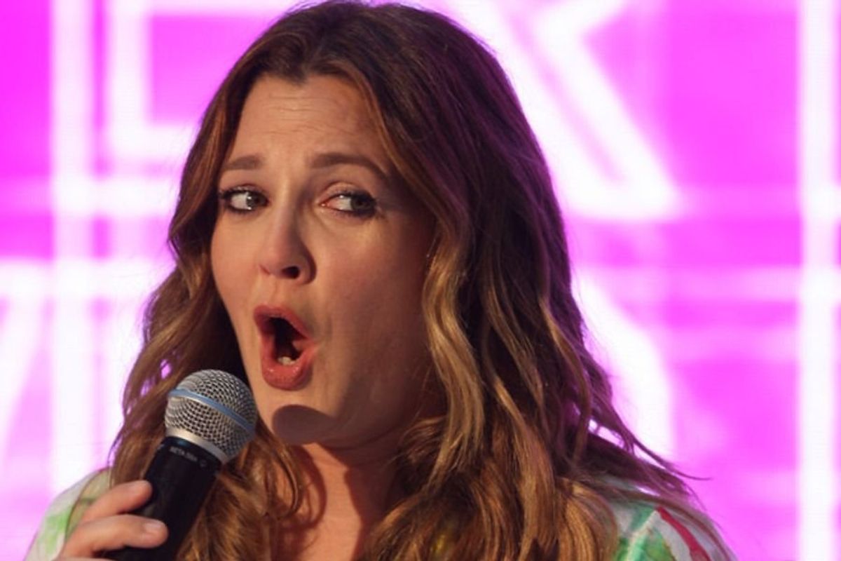 Drew Barrymore speaking into a microphone