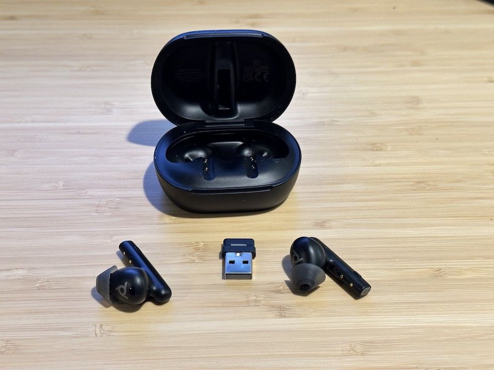 a photo of Poly Voyager Free 60+ UC Wireless Earbuds with Touchscreen Charging Case and BT700 Bluetooth Adapater