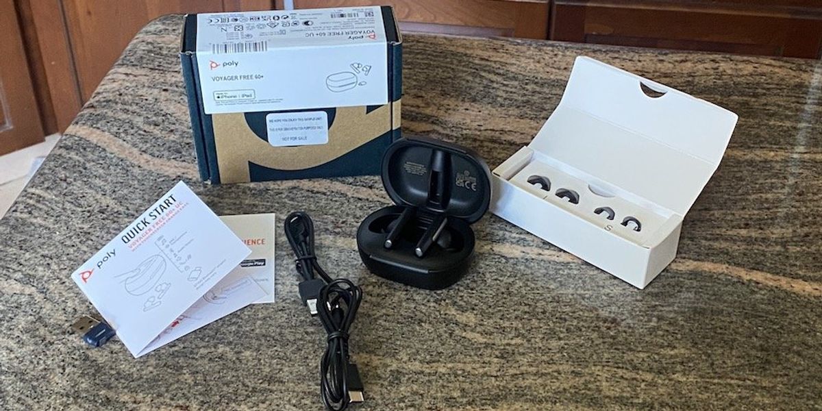 a photo of Poly Voyager Free 60+ UC Wireless Earbuds with Touchscreen Charging Case unboxed