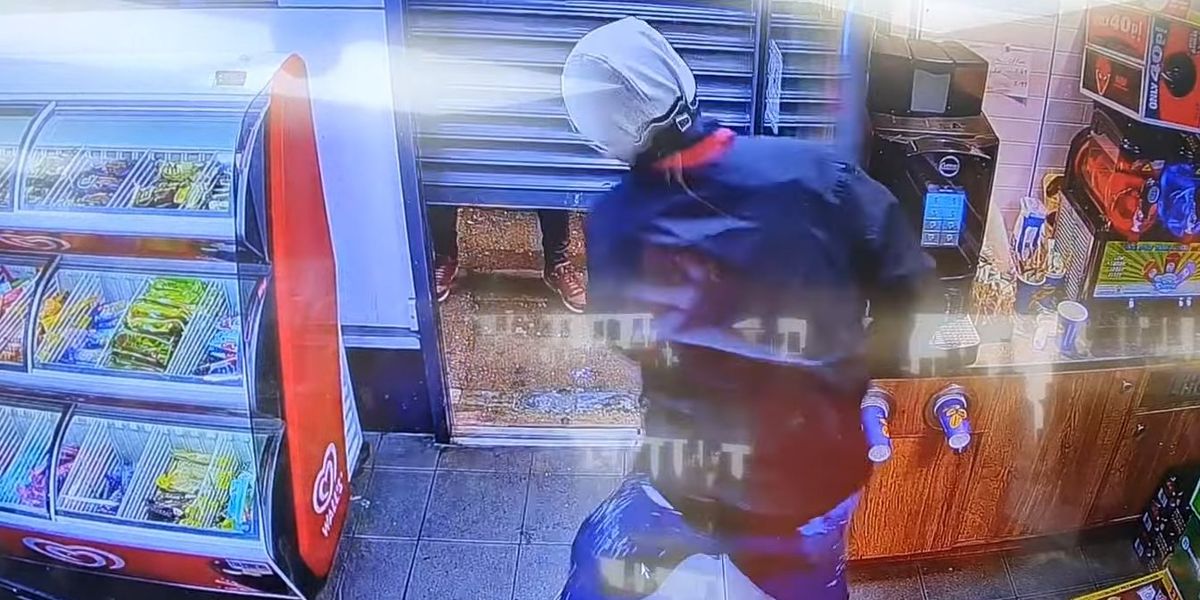 Video: British thief's 'Indiana Jones-style slide' to get past closing shutters fails. Stuck, he drinks to his misfortune.
