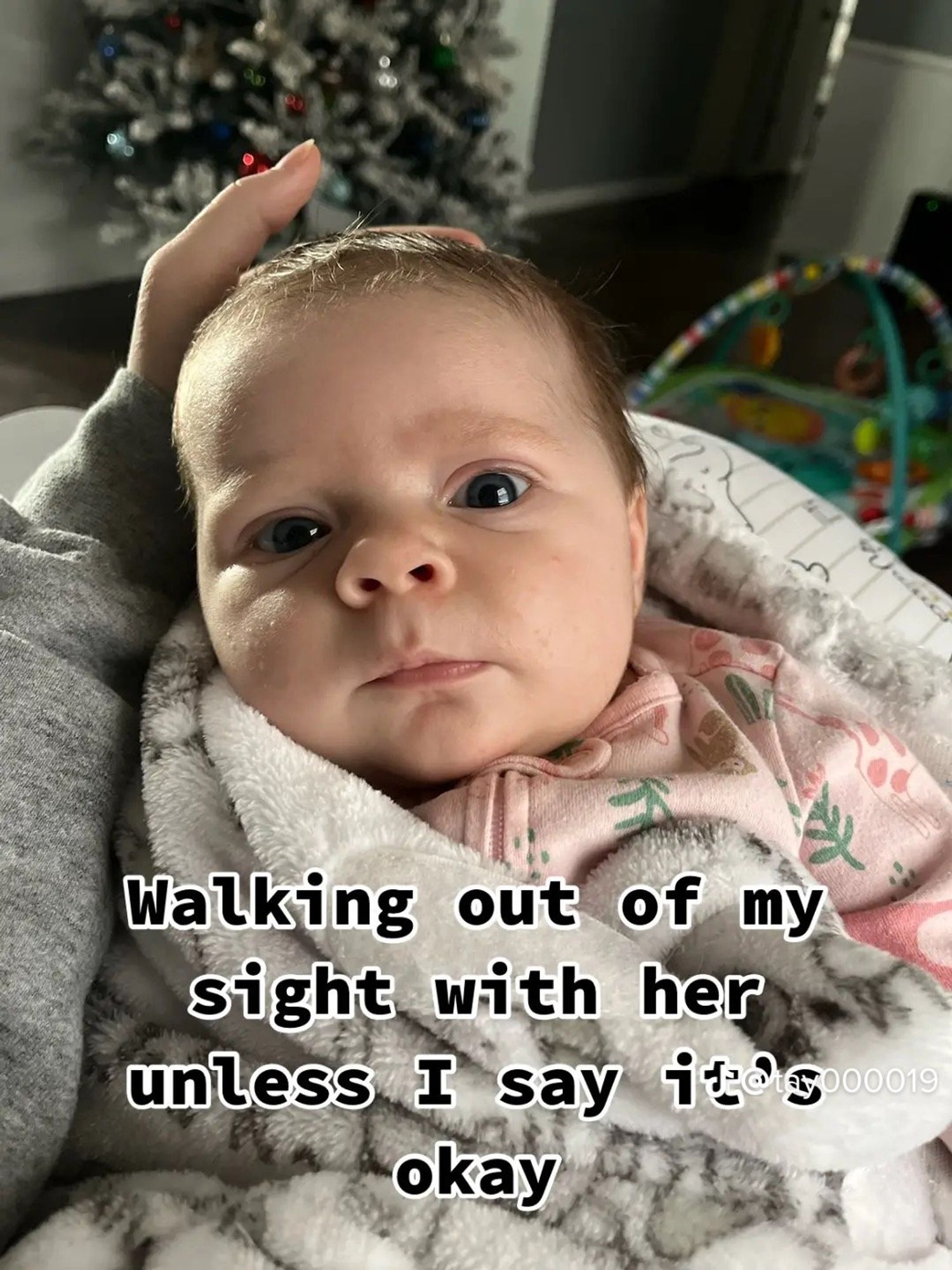 newborn looking at camera with text overlay