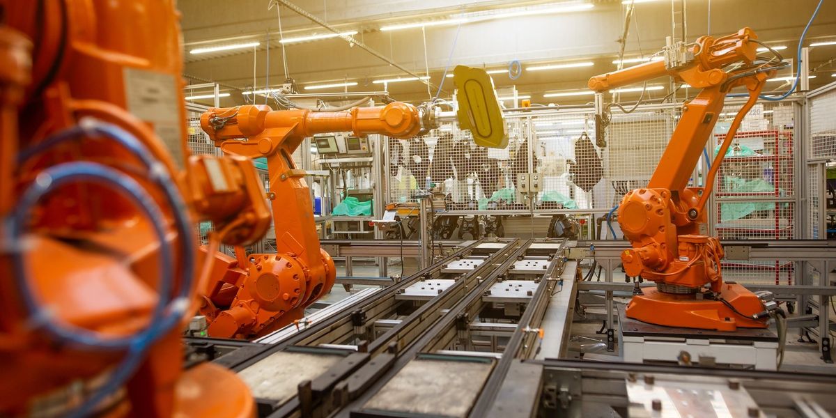 Orange machines work the assembly line
