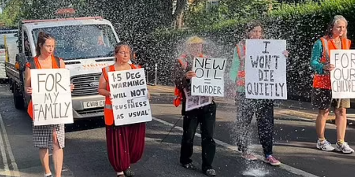 NextImg:Anti-oil activists drenched in water by angry resident after protest blocks highway in UK town