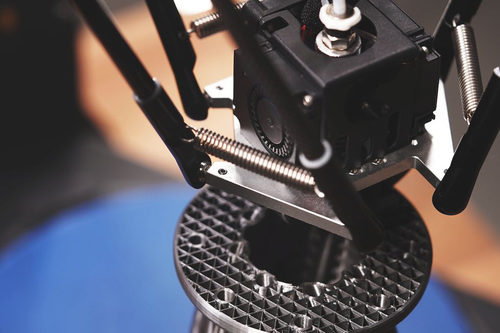 close up of 3D printer making metal object