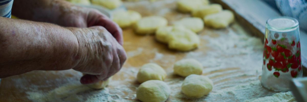image of a woman's hands rolling dough to make tortillas