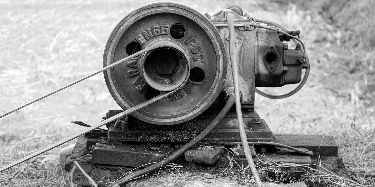 A black and white photo of an Old Motor Engine for pumping water under the earth