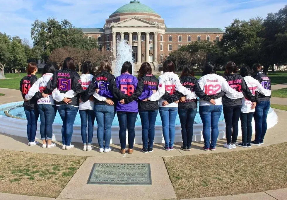 A photo of girls from the Southern Methodist University, Pi Chapter holding hands with their backs turned toward the camera. Image via Facebook