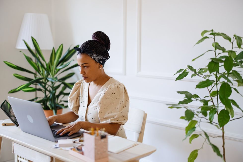focused-Black-woman-sitting-at-desk-working-from-home