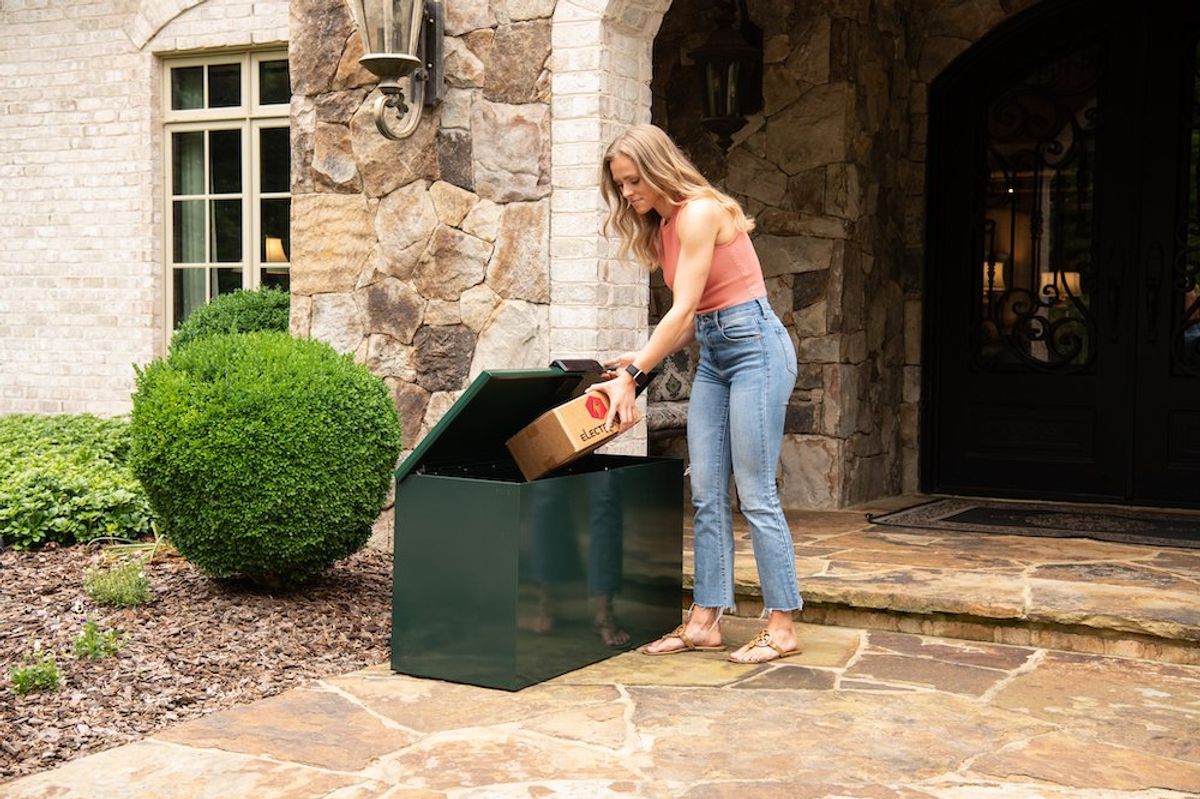 a photo of a woman taking a package out of Loxx Boxx Household