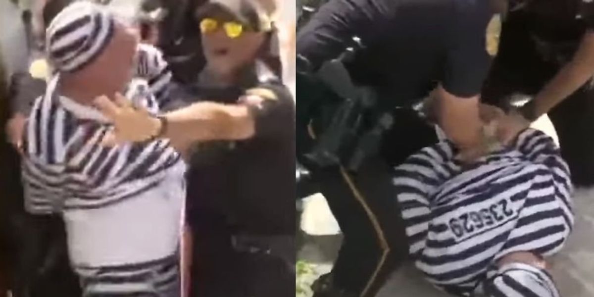NextImg:Protester tackled and arrested for rushing at Trump's motorcade with a protest sign after arraignment in Miami