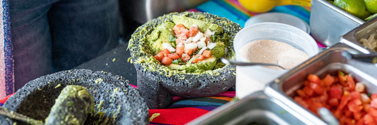 an image of a guacamole with tomato and onion