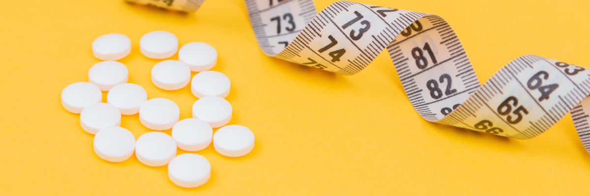 white round medication pill on yellow surface