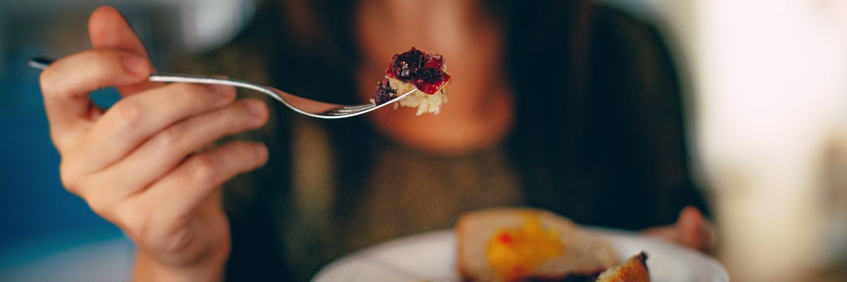 woman holding plate of cake