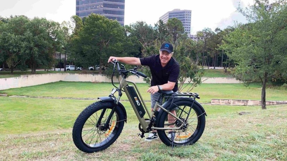 a man standing next to KBO Tornado Electric Fat Tire Bike