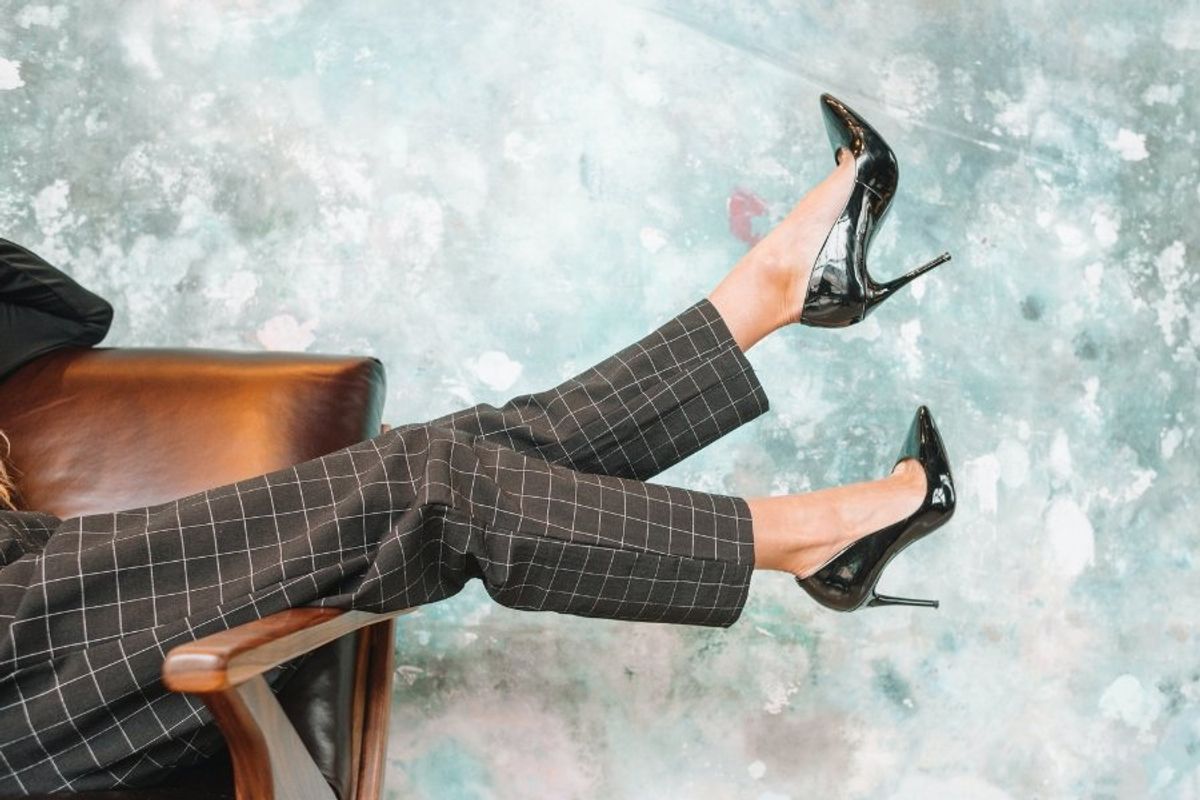 woman wearing glossy black high heels