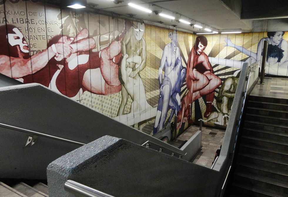 a mural in a mexico city metro station depicting luchadoras in different lock poses