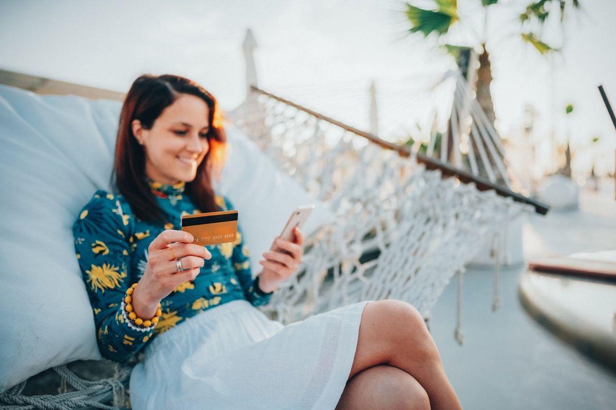 a woman using a credit card on her smartphone