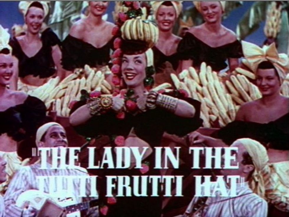 Cropped screenshot of Carmen Miranda from the trailer for the film The Gang's All Here that reads 